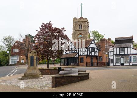 St. John the Baptist Church as seen from the High Street, Pinner, Middlesex, England, UK. First and second world wars memorial stands in foreground. Stock Photo