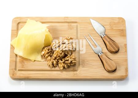 Blue cheese with nuts on metal tray and wooden table and dark background. Stock Photo