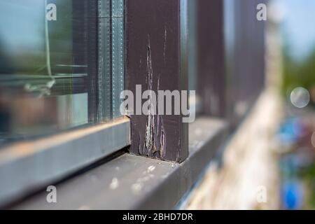 Damaged modern window frames in bad condition that need to be refurbished and repainted Stock Photo
