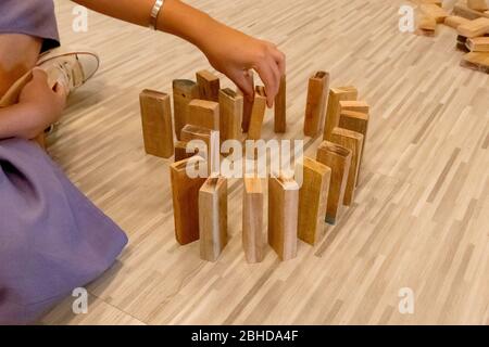The Wood domino lined up by a man's hand Stock Photo