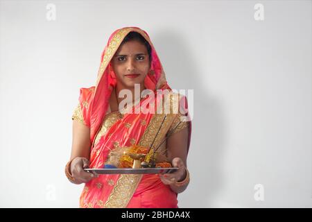 Indian Woman holding pooja thali, Indian woman performing puja Stock Photo