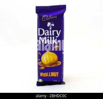 Alberton, South Africa - a bar of Cadbury dairy milk whole nut chocolate isolated on a clear background image with copy space Stock Photo