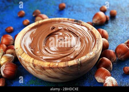 Homemade hazelnut spread in wooden bowl. Hazelnut Nougat cream on table Stock Photo