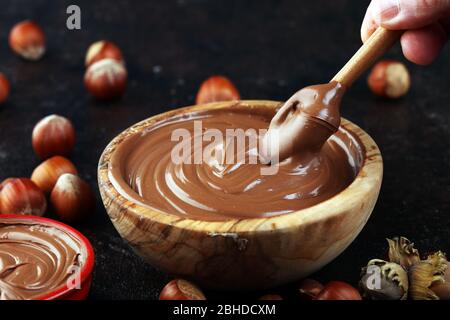 Homemade hazelnut spread in wooden bowl. Hazelnut Nougat cream on table Stock Photo