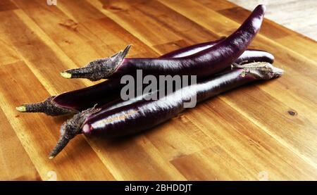 long italian eggplants. variety called perlina. purple healthy vegetable long aubergine on background Stock Photo