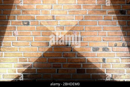 Aged and weathered brick wall textures with bright spotlight illumination Stock Photo