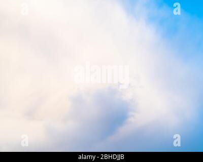 part of large white cloud in blue sky on spring afternoon Stock Photo