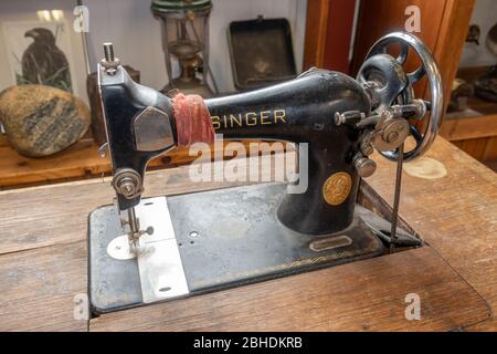 A vintage Singer manual sewing machine on display inside the Bjarnarhöfn Shark Museum, Bjarnarhöfn, Snaefellsnes peninsula, Iceland. Stock Photo