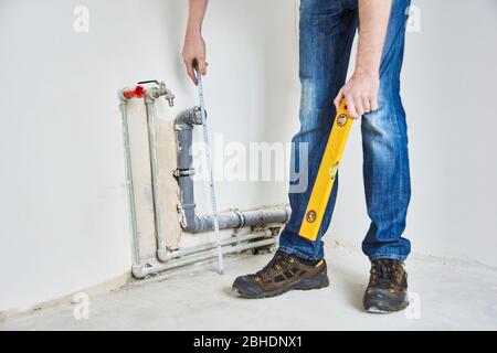 Plumbing in the house. Installation of sewer pipes in the kitchen of an apartment interior during renovation works. Stock Photo