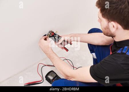 crimping pliers on the man hands. installation, repairs in the new flat Stock Photo