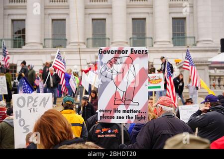 Wisconsinites rallied at the Capitol of Wisconsin protest against safer at home order due to the Coronavirus pandemic to allow the state reopen. Stock Photo