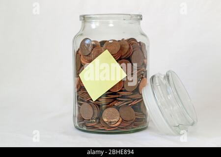 Glass savings jar with coins collection or savings for a rainy day Stock Photo