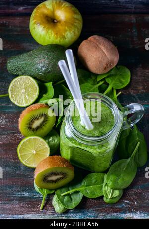 Healthy green smoothie on a dark wooden background. Vegetarian food concept, detox, fitness. Selective focus Stock Photo