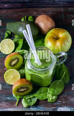 Healthy green smoothie on a dark wooden background. Vegetarian food concept, detox, fitness. Selective focus Stock Photo