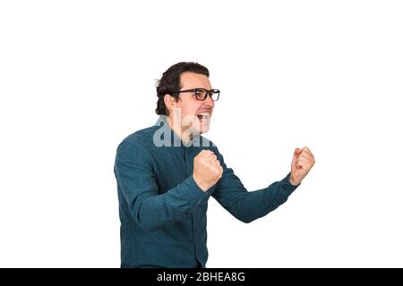 Hysterical and passionate businessman keeps fists tight, shouting and screaming, celebrates success like crazy, isolated over white background. Busine Stock Photo