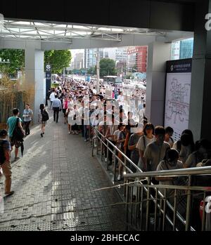 Crowd of Chinese people in a row entering the metro station in Beijing, China. Stock Photo