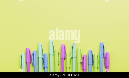 Multi-colored markers on a yellow background with free space. Minimalistic concept Stock Photo