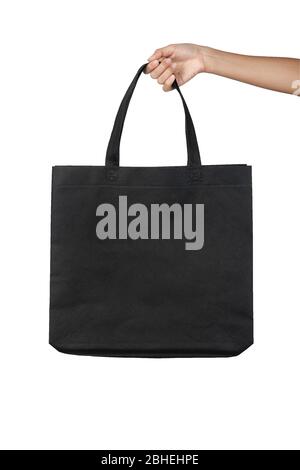Hand holding blank black fabric canvas bag isolated on white background with clipping path, eco concept. Stock Photo