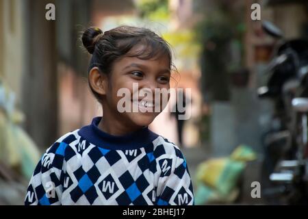 Happy young poor Indian street girl laughing. India Stock Photo