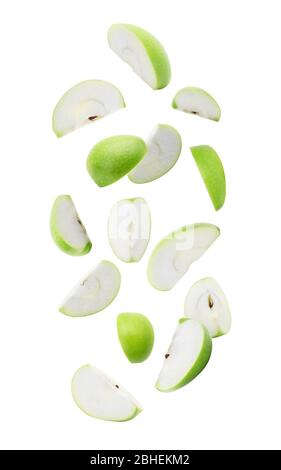 Slice ripe green apple falling isolated on white background with clipping path. Stock Photo