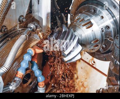 gear wheel is machined on a horizontal CNC machine center with  rotating tool and splashing coolant