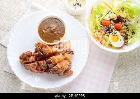 Deep fried pork knuckle with mushroom gravy source, fresh vegetable and salad cream source Stock Photo