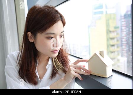 girl investment concepts with the wooden house model Stock Photo