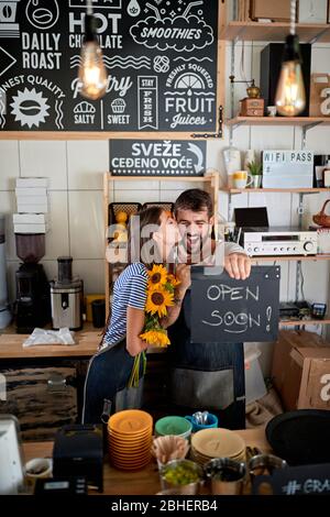 exited young couple having fun in their own cafe before opening. enthusiastic, excitement, joy, startup, business Stock Photo