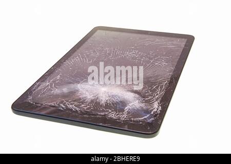Tablet with broken screen glass isolated over white Stock Photo