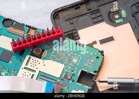 Disassembled tablet device during repairing process, close image Stock Photo