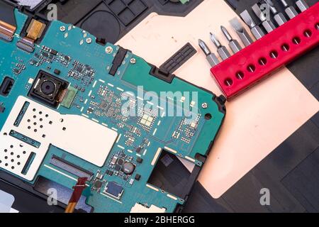 Tablet with removed cover, close image during repair process Stock Photo