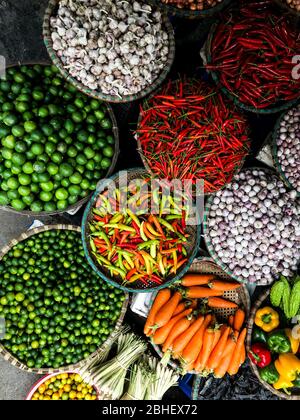 Fresh vegetables for sale at street food market in the old town of Hanoi, Vietnam. Stock Photo