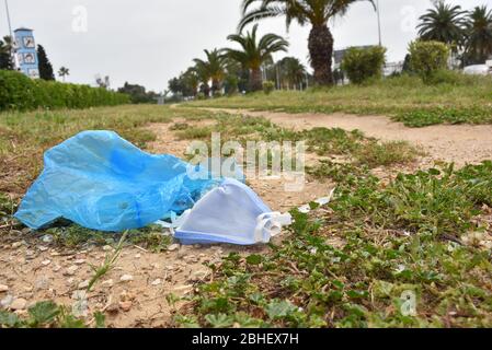 Tunis, Tunisia. 25th Apr, 2020. A discarded face mask lies on the ground during quarantine.At this time of the corona virus contagion, latex gloves and surgical masks are abandoned by people in parking lots, grassy fields, playgrounds and in the streets. Many with the potential to carry the Covid-19 virus inside. Credit: SOPA Images Limited/Alamy Live News Stock Photo