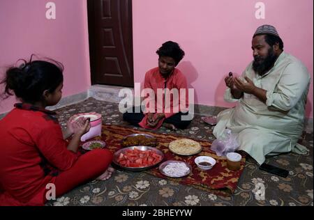 Faithful Muslims break their fast at their home, on the first day of the Holy month of Ramadan-ul-Mubarak, during nationwide lockdown as a preventive measure against the spread of the Coronavirus (COVID-19), in Karachi on Saturday, April 25, 2020. Stock Photo