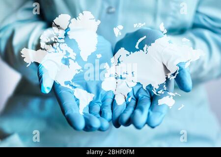 Abstract image of the world map on the hands of the doctor in medical gloves. Close up. Stock Photo