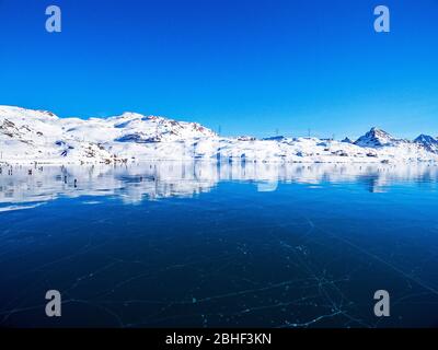 Frozen White Lake - Bernina Pass - Switzerland - Panoramic aerial view Stock Photo