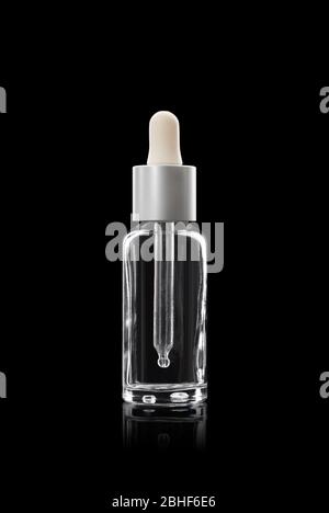 glass dropper bottle. With a white cap on a black background Stock Photo