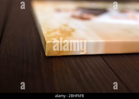 Photo canvas print. Sample of stretched photography with gallery wrapping on a wooden stretcher bar. Lateral side view, closeup. Selective focus Stock Photo