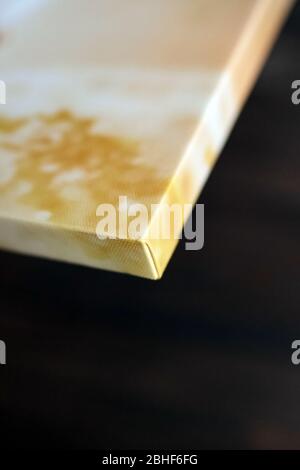 Photo canvas print. Sample of stretched photography with gallery wrapping on a wooden stretcher bar. Lateral side view, closeup. Selective focus Stock Photo