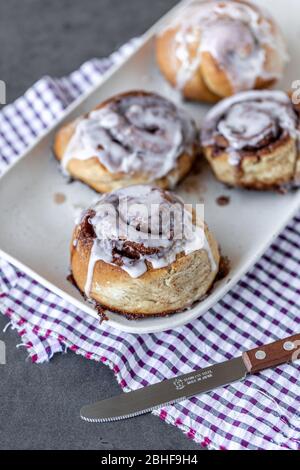 Fresh Homemade Cinnamon Rolls made on a plate with a napkin for breakfast Stock Photo