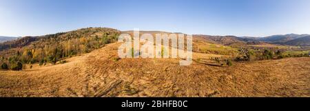 Aerial drone view 180 degrees panoramic scenic landscape of mountains and forests, slopes and valleys. Carpathians, Eastern Beskids. Stock Photo