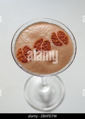 shaken and iced cocktail based on espresso and amaretto decorated with ground coffee beans Stock Photo