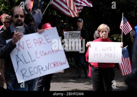 Salem, USA. 25th Apr, 2020. Protesters gather outside Governor Kate Brown's residence in Salem, Ore., on April 25, 2020, calling for novel coronavirus restrictions to be lifted so that people can get back to work. (Photo by Alex Milan Tracy/Sipa USA) Credit: Sipa USA/Alamy Live News Stock Photo