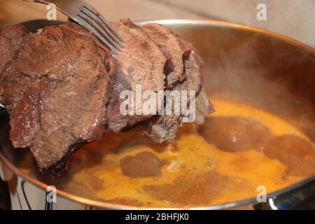 Boiled meat of veal and beef with vegetable sauce Stock Photo