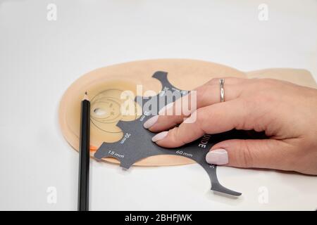 Top view on colostomy bag, supplies needed after colostomy surgery - colon cancer treatment. Ostomy bag with filter in skin color. Medical theme. Stom Stock Photo