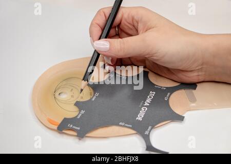 Top view on colostomy bag, supplies needed after colostomy surgery - colon cancer treatment. Ostomy bag with filter in skin color. Medical theme. Stom Stock Photo