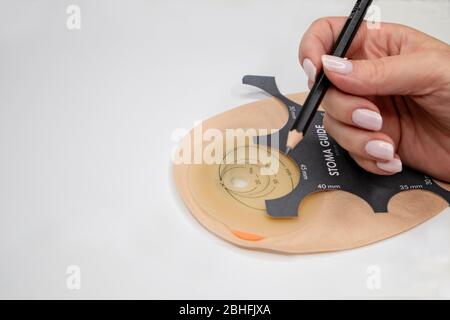 Top view on colostomy bag, supplies needed after colostomy surgery - colon cancer treatment. Ostomy bag with filter in skin color. Medical theme. Stom Stock Photo