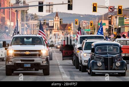 Kalispell, Montana, USA. 24th Apr, 2020. Vehicles along Main Street in downtown Kalispell participate in Kruise Kalispell. For the 3rd Friday evening in a row Kruise Kalispell has held this event in spite of Montana's Stay At Home Order by the Governor due to the Covid-19 pandemic . Hundred's of people in cars, on motorcycles and on foot gather for the events as a way to have public gatherings. Credit: Kent Meireis/ZUMA Wire/Alamy Live News Stock Photo