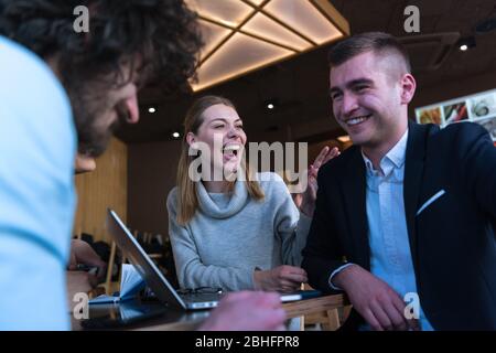 Work colleagues discussing new marketing strategies during a coffee break Stock Photo
