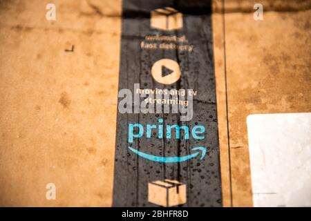 Lyon, France - Aug 7, 2019: Close-up detailed macro shot of wet Amazon Prime parcel cardboard with multiple water drops being delivered under rainy we Stock Photo